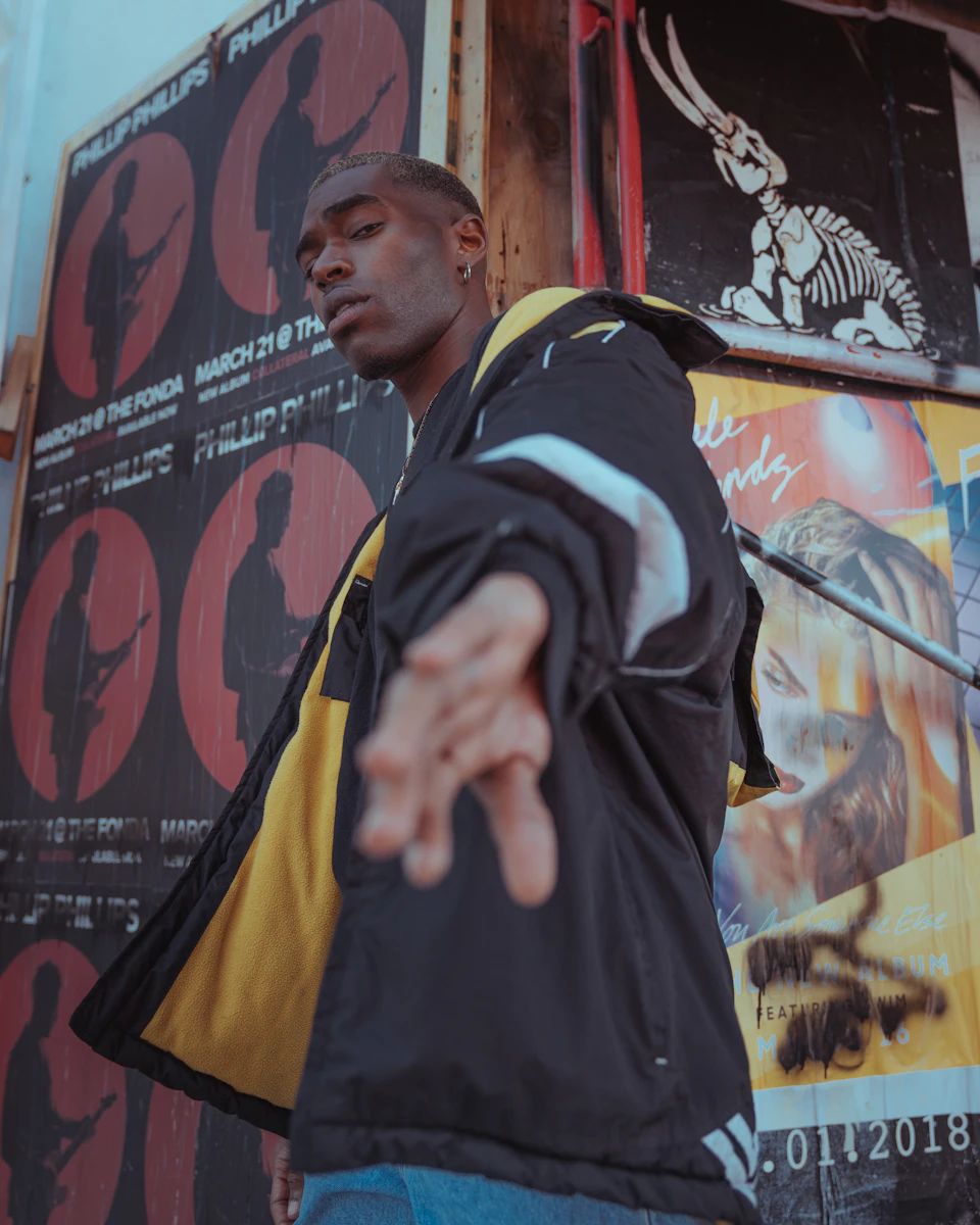 Street-style portrait of a person in a dark layered look.